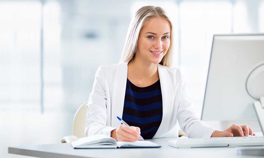 pretty woman sitting behind a computer